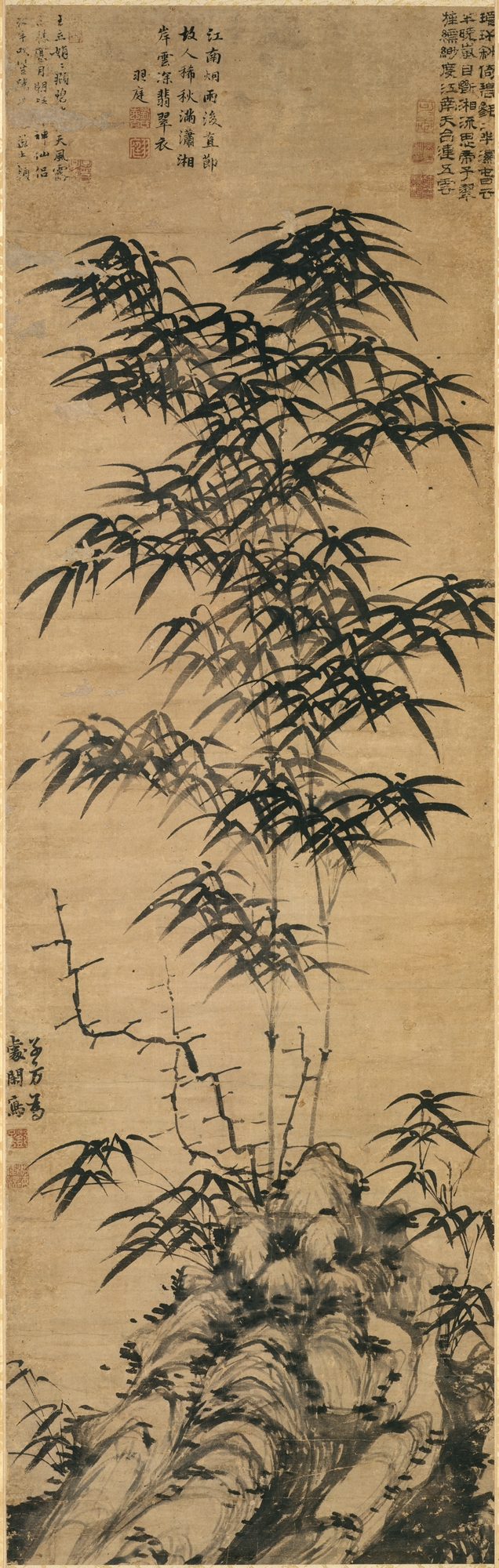 A Chinese ink painting of bamboo growing among rocks, with inscriptions above
